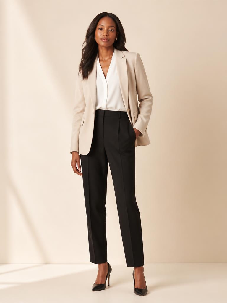 Woman wearing a beige blazer with black tailored trousers for a professional day